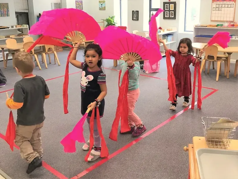 Children dancing with a paper dragon