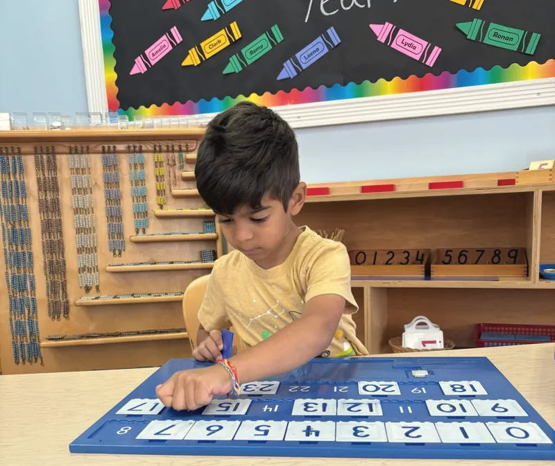A boy working on the hundred board