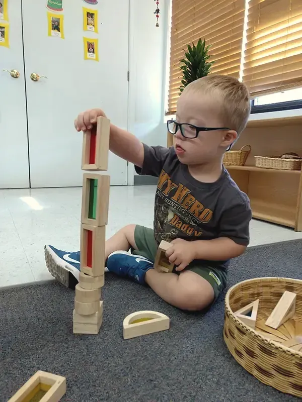 A toddler building a tower
